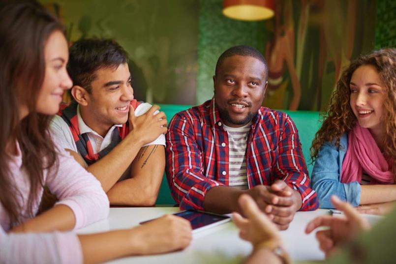 Diverse teens talking at a table