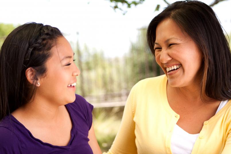 Happy mother and teen daughter engaged in conversation